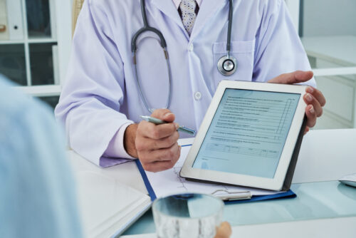 Doctor asking patient to fill the survey before medical treatment