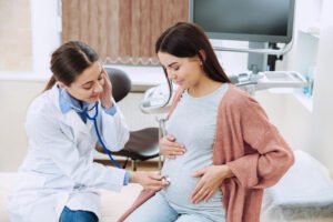 obstetrician and gynecologist analyzing a woman through ultrasound software